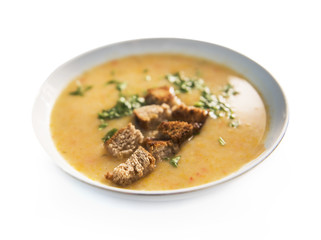 Squash soup in a bowl, isolated on a white background.