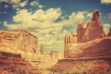 Fototapeta na wymiar Old postcard from Wild West, retro toned photo, Arches National Park, Utah, USA.