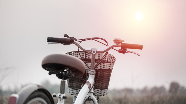 beautiful landscape image with Bicycle at sunset ; vintage filte