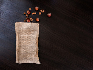 Fototapeta na wymiar hazelnuts and Chufa spilled from a small esparto bag