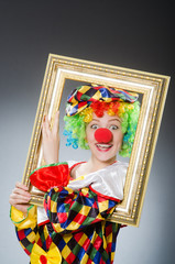 Clown with picture frame in funny concept