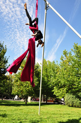 cheerful child training on aerial silks