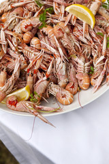Prawns, lemon and herbs on a plate