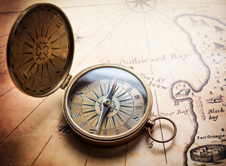 Fototapeta na wymiar Old compass on vintage map. Retro stale.