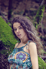 portrait of a beautiful woman with curly hair in nature