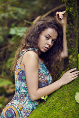 portrait of a beautiful woman with curly hair in nature