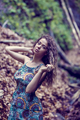 Naklejka premium portrait of a beautiful woman with curly hair in nature
