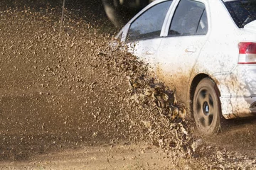 Muurstickers Motorsport Mud debris splash from a rally car ( Focus at mud debis)