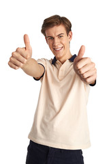 Portrait of joyful young boy showing "okay" with thumb up over white background. Smiling Caucasian male with outstretched arms posing in studio.