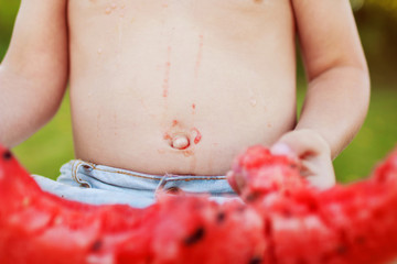 child holding a piece of watermelon
