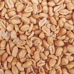 salted and fried peanuts close up, food background