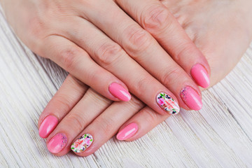 Light pink nail art with printed flowers
