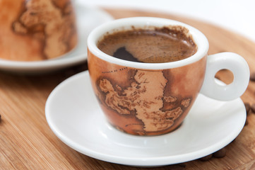 Cup of coffee on the wooden board