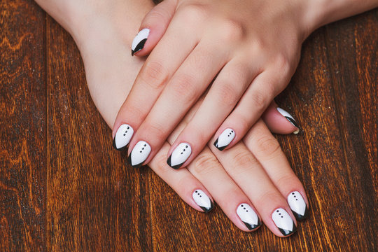 Black and white  nail art on wooden background