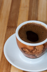 Cup of coffee on the wooden board