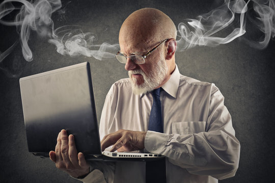 Angry man using a laptop