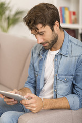 young woman using digital tablet at home