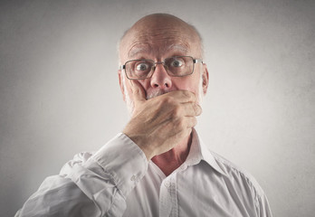 Shocked man covering his mouth with his hand