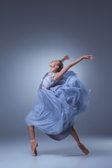 Obraz premium The beautiful ballerina dancing in blue long dress 