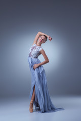 Fototapeta premium The beautiful ballerina dancing in blue long dress 