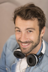 young man listenig music with digital tablet at home
