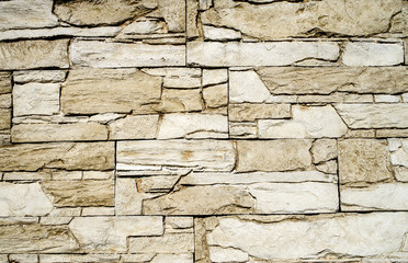 Decorative relief cladding slabs imitating stones on wall