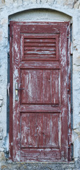 Fototapeta na wymiar old brown yellow ragged shabby wooden door