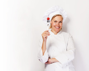 Woman chef showing a sign perfect, with tomato on fork, over whi