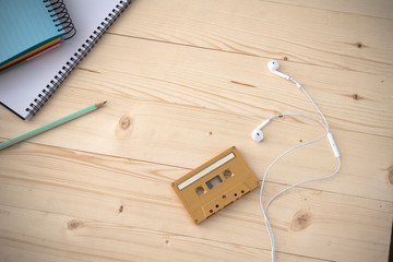 notebook , earphone and cassette on desktop
