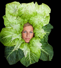 Cute woman with salad leaves arranged around her head
