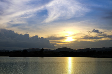 Sunset behind the lake and hill at nightfall