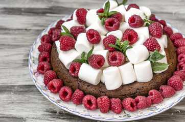 Oatmeal cake with marshmallow and raspberry  