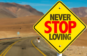 Never Stop Loving sign on desert road