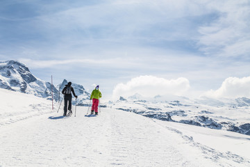 Women walking on ski in the snow mountain.