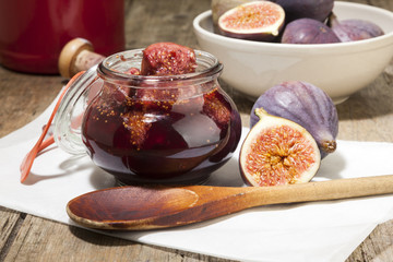 Pickled figs in port wine with cooking spoon and fresh fruits