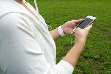 Fitness woman using smartphone in the park