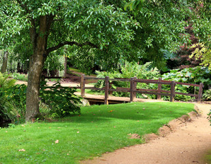 English garden with footbridge over a stream