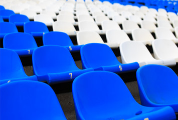 Naklejka premium empty seats in the stadium. color separation sector with seats at a sports stadium
