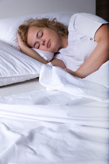 Young woman sleeping in Bed at night.