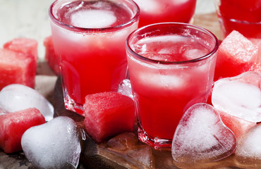 Watermelon cold drink with ice in a heart shape, selective focus