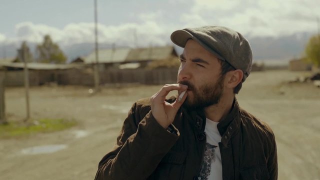 Man smoking cigarette in a countryside