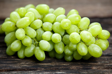 Green grape, close up  on old wooden table. background. selected focus