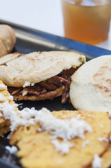 Typical venezuelan food: arepas with shredded beef and cachapas with cheese.