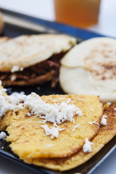 Typical venezuelan food: arepas with shredded beef and cachapas with cheese.