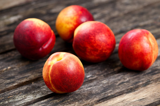 Fresh juicy Nectarine Fruit close up, on old wooden table. background. selected focus