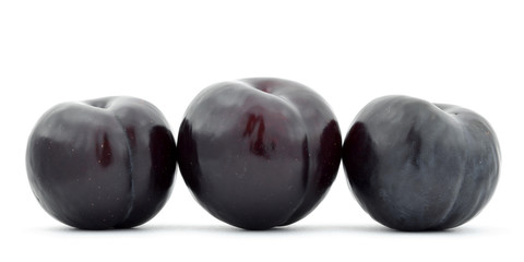 Three plums isolated on white background