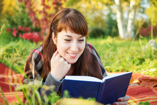 Beautiful Girl Reading A Book In Autumn Park