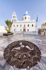 Mosaic in ahead of a church in Oia
