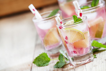 Pink cocktail with lime and mint, selective focus