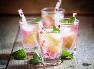 Pink cocktail with lime and mint, selective focus